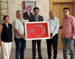 Yerköy Halk Eğitimi Merkezi yöneticileri, tayini çıkan Kaymakam Muharrem Coşgun’a